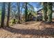 View of the spacious backyard with mature trees and home in the distance at 2814 Lloyd Rd, Decatur, GA 30034