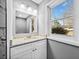 Bathroom vanity featuring granite countertops, white cabinets, and a stylish mirror with modern lighting at 2814 Lloyd Rd, Decatur, GA 30034