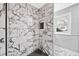Newly renovated shower with a unique black and white marble tile design, plus a built-in niche at 2814 Lloyd Rd, Decatur, GA 30034