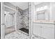 Beautifully remodeled bathroom with shower featuring distinct marble tile and a modern vanity at 2814 Lloyd Rd, Decatur, GA 30034