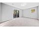 Empty bedroom with carpeted floors and glass sliding doors out to the deck at 2814 Lloyd Rd, Decatur, GA 30034