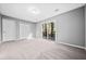 Bright bedroom with neutral carpet, fresh gray paint, and access to a private outdoor deck at 2814 Lloyd Rd, Decatur, GA 30034