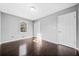 Clean, bright bedroom with neutral walls, closet, and dark floors features natural lighting at 2814 Lloyd Rd, Decatur, GA 30034