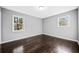 Light and airy bedroom has dark wood floors, neutral paint, and natural lighting at 2814 Lloyd Rd, Decatur, GA 30034