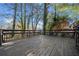 Exterior view of the backyard deck with railing and steps into the wooded yard at 2814 Lloyd Rd, Decatur, GA 30034