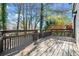 Exterior view of backyard deck with railing and steps into backyard with mature trees at 2814 Lloyd Rd, Decatur, GA 30034