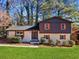 Charming home featuring a modern two-tone exterior with orange shutters, manicured lawn, and mature trees at 2814 Lloyd Rd, Decatur, GA 30034