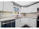 Updated kitchen features white cabinets, granite countertops, and stainless steel appliances at 2814 Lloyd Rd, Decatur, GA 30034