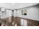 Bright living room with hardwood floors, stairs, and ample natural light from a large window at 2814 Lloyd Rd, Decatur, GA 30034