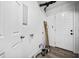Utility room with a door to outside, flooring, and pipes at 2814 Lloyd Rd, Decatur, GA 30034