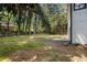 Expansive backyard with lush greenery, mature trees, and a wooden fence offering privacy at 5346 Kelleys Mill Cir, Stone Mountain, GA 30088