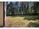 Spacious backyard featuring lush greenery, mature trees, and ample space for outdoor activities at 5346 Kelleys Mill Cir, Stone Mountain, GA 30088