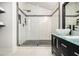 Contemporary bathroom with a glass-encased shower featuring marble tiling, and a modern vanity with a vessel sink at 5346 Kelleys Mill Cir, Stone Mountain, GA 30088