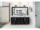 Modern bathroom features a double sink vanity, and a frameless glass shower with marble and black tiling accents at 5346 Kelleys Mill Cir, Stone Mountain, GA 30088
