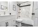 Classic bathroom showcasing a tub with marble-style tiling, complemented by a white vanity and fixtures at 5346 Kelleys Mill Cir, Stone Mountain, GA 30088