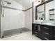 Sleek bathroom showcasing a glass-enclosed shower with marble tiling and a stylish black vanity with a vessel sink at 5346 Kelleys Mill Cir, Stone Mountain, GA 30088