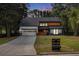 Modern two-story home with a dark roof, light wood accents, and a long driveway at 5346 Kelleys Mill Cir, Stone Mountain, GA 30088