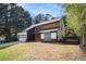 Modern two-story home with a dark roof, light wood accents, and an attached garage at 5346 Kelleys Mill Cir, Stone Mountain, GA 30088