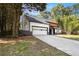 Modern two-story home with a dark roof, light wood accents, and an attached garage at 5346 Kelleys Mill Cir, Stone Mountain, GA 30088