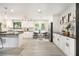 Bright kitchen with white cabinets, stainless steel appliances, black countertops and a table with two chairs at 5346 Kelleys Mill Cir, Stone Mountain, GA 30088