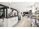 Open concept kitchen with white cabinets, black countertops, stainless steel appliances and view of living room at 5346 Kelleys Mill Cir, Stone Mountain, GA 30088