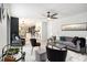 Open-concept living room with modern furnishings, stylish decor, a ceiling fan and a view of the kitchen at 5346 Kelleys Mill Cir, Stone Mountain, GA 30088