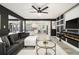 Open living room with fireplace, gray sofa, and a view to the kitchen island at 5346 Kelleys Mill Cir, Stone Mountain, GA 30088