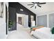 Bedroom featuring a king bed, ensuite bathroom and two closets, along with a contrasting dark accent wall at 5346 Kelleys Mill Cir, Stone Mountain, GA 30088