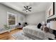 A cozy bedroom with hardwood floors, area rug, ceiling fan, and two lounge chairs at 939 Whistler Ln, Canton, GA 30114