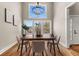 Cozy dining room with natural lighting, hardwood floors and a modern chandelier at 939 Whistler Ln, Canton, GA 30114