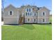Inviting exterior elevation featuring a spacious front yard and a charming two-story design with a light gray exterior at 939 Whistler Ln, Canton, GA 30114