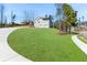 Beautifully landscaped front yard with a long driveway leading to a home with an attached garage at 939 Whistler Ln, Canton, GA 30114