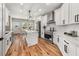 Modern kitchen featuring white cabinetry, stainless steel appliances, quartz countertops, and a center island at 939 Whistler Ln, Canton, GA 30114
