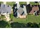 Aerial view of backyard including patio with table and chairs and well-landscaped yard at 940 River Valley Dr, Dacula, GA 30019