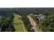 An aerial view showcasing the golf course, tennis courts, and surrounding lush greenery, creating a vibrant and active community setting at 940 River Valley Dr, Dacula, GA 30019