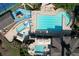 Aerial view of large pool and playground with lounge chairs and tables with umbrellas at 940 River Valley Dr, Dacula, GA 30019