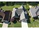 Aerial view of a beautiful brick home with a well-manicured lawn and a two-car garage at 940 River Valley Dr, Dacula, GA 30019