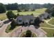 Aerial view showcasing the clubhouse, golf course, flags, parking lot, and golf carts at 940 River Valley Dr, Dacula, GA 30019