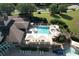 Aerial view of outdoor pool with lounge chairs, tables, and umbrellas, near a roadway at 940 River Valley Dr, Dacula, GA 30019
