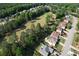 Elevated aerial view of a community on the golf course with mature trees and lush lawns at 940 River Valley Dr, Dacula, GA 30019