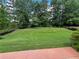 Lush green backyard with mature trees, offering a private and serene outdoor space at 940 River Valley Dr, Dacula, GA 30019