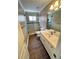 Bathroom with tile floors, walk in shower, single sink vanity, and window at 940 River Valley Dr, Dacula, GA 30019