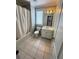 Bathroom with a toilet, tub-shower combo, tile floors, and a single sink vanity at 940 River Valley Dr, Dacula, GA 30019