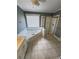 Bathroom featuring a garden tub and shower with glass doors plus tile floors at 940 River Valley Dr, Dacula, GA 30019