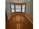 Cozy breakfast nook with hardwood floors, three windows and a chandelier at 940 River Valley Dr, Dacula, GA 30019