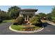 Beautifully landscaped clubhouse featuring a stone wall, and flower beds near a circular driveway at 940 River Valley Dr, Dacula, GA 30019