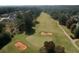 Scenic aerial shot of a golf course with sand traps, a manicured green, and tree-lined fairways within a residential community at 940 River Valley Dr, Dacula, GA 30019