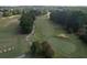 Birds eye view of the serene golf course offering a peaceful retreat amidst lush greenery, with sand traps and winding paths at 940 River Valley Dr, Dacula, GA 30019