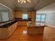 Bright kitchen with wood cabinets, granite countertops, island with sink and adjacent breakfast area at 940 River Valley Dr, Dacula, GA 30019