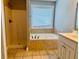 Bathroom with separate tub and shower, tile flooring, and modern fixtures at 1714 Boulder Walk Se Ln, Atlanta, GA 30316